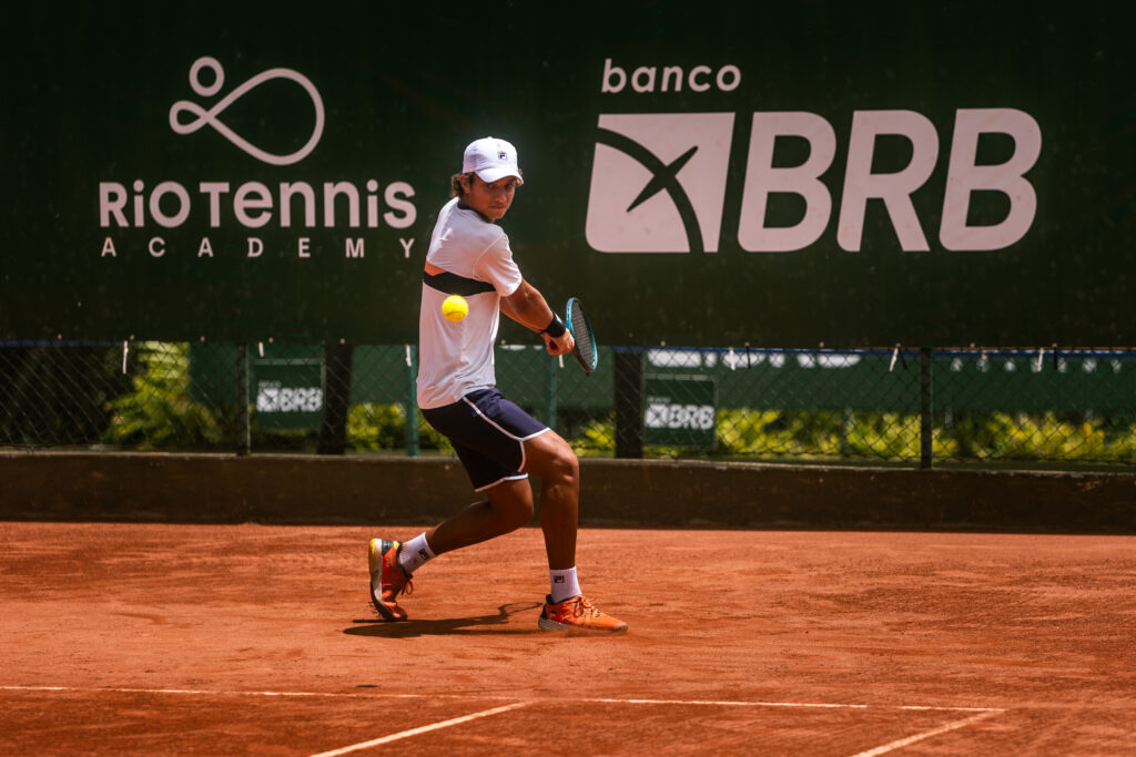 Cadu Lino, jovem atleta da Rio Tennis, jogando tênis e fazendo um backhand